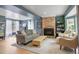 Cozy living room with a brick fireplace, comfortable seating, and neutral tones at 4570 Irving St, Denver, CO 80211