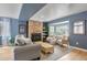 Comfortable living room with stone fireplace, bay window, and blue walls at 4570 Irving St, Denver, CO 80211
