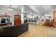 Open floor plan showcasing the living, kitchen, and dining areas with hardwood floors and modern decor at 4570 Irving St, Denver, CO 80211