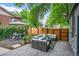 Outdoor patio area complete with comfortable seating arrangements and a wooden privacy fence at 4570 Irving St, Denver, CO 80211