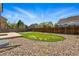 Landscaped backyard with rock cover, grassy area, wooden fence, and patio, offering outdoor living space at 19721 E Vassar Ave, Aurora, CO 80013