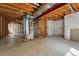Unfinished basement with exposed beams, mechanicals, and a concrete floor, ready for customization at 19721 E Vassar Ave, Aurora, CO 80013