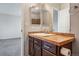 Bathroom vanity with double mirrors, tile countertop, and dark wood drawers at 19721 E Vassar Ave, Aurora, CO 80013