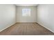 Bedroom featuring a neutral wall, carpet, and a window bringing natural light at 19721 E Vassar Ave, Aurora, CO 80013