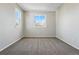 Bright bedroom featuring neutral walls, plush carpeting, and well-lit by natural light from the double windows at 19721 E Vassar Ave, Aurora, CO 80013