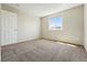 Bright bedroom featuring neutral walls, plush carpeting, and well-lit by natural light from a window at 19721 E Vassar Ave, Aurora, CO 80013