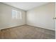 Bedroom with a neutral wall, carpet, and a window bringing natural light at 19721 E Vassar Ave, Aurora, CO 80013