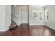 Welcoming foyer with hardwood floors, staircase, and bright windows, offering a warm and inviting atmosphere at 19721 E Vassar Ave, Aurora, CO 80013
