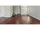 Open foyer featuring hardwood floors, staircase, and natural light from large windows, creating an inviting entrance at 19721 E Vassar Ave, Aurora, CO 80013
