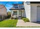 Close up of the front entrance, showing landscaped garden, and two-story house at 19721 E Vassar Ave, Aurora, CO 80013