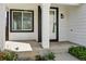 Exterior view of the covered front porch and entryway at 19721 E Vassar Ave, Aurora, CO 80013