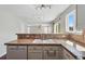 Kitchen featuring a breakfast bar, tile countertops, and stainless steel appliances for easy meal preparation at 19721 E Vassar Ave, Aurora, CO 80013