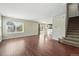 Bright and open-concept living space featuring hardwood floors, staircase, and sliding glass doors to the outdoors at 19721 E Vassar Ave, Aurora, CO 80013