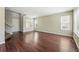 Spacious living room with gleaming hardwood floors, a bright airy ambiance, and staircase access at 19721 E Vassar Ave, Aurora, CO 80013