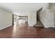 Spacious living room with wood floors that opens to a modern kitchen and staircase at 19721 E Vassar Ave, Aurora, CO 80013