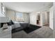 Serene main bedroom featuring plush carpeting, soft lighting, and an ensuite bathroom for added privacy at 19721 E Vassar Ave, Aurora, CO 80013