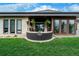 Spacious back patio featuring a cozy seating area, outdoor dining space, and beautiful landscaping at 6 Wilder Ln, Littleton, CO 80123