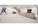 Spacious basement with carpet, television, and decorative wall art at 6 Wilder Ln, Littleton, CO 80123