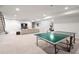 Finished basement with ping pong table and entertainment area at 6 Wilder Ln, Littleton, CO 80123