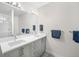 Bright bathroom with double vanity sinks and modern lighting at 6 Wilder Ln, Littleton, CO 80123
