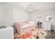 Cozy bedroom with a pink daybed, decorative wall paneling, and a walk-in closet, designed for comfort and style at 6 Wilder Ln, Littleton, CO 80123