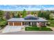 Stunning home featuring a well-maintained yard, three-car garage, and modern architectural details at 6 Wilder Ln, Littleton, CO 80123
