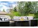 Relaxing outdoor seating area with a modern fire pit, comfortable chairs, and scenic views at 6 Wilder Ln, Littleton, CO 80123
