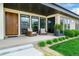 Inviting front porch with comfortable seating, lush landscaping, and a stylish entrance at 6 Wilder Ln, Littleton, CO 80123