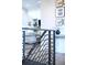 Close-up of a hallway featuring modern railings, hardwood floors, and stylish wall decor at 6 Wilder Ln, Littleton, CO 80123