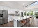 Bright, modern kitchen with a large center island, stainless steel appliances, and ample cabinet space at 6 Wilder Ln, Littleton, CO 80123