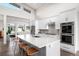Open-concept kitchen featuring a spacious island, stainless steel appliances, and modern cabinetry at 6 Wilder Ln, Littleton, CO 80123
