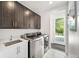 Modern laundry room with stainless steel washer and dryer at 6 Wilder Ln, Littleton, CO 80123