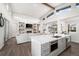Open floor plan featuring a modern kitchen with a living room that includes a fireplace and built-in shelving at 6 Wilder Ln, Littleton, CO 80123