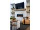 Modern living room featuring a fireplace, built-in shelving, and a stylish leather chair with ottoman at 6 Wilder Ln, Columbine Valley, CO 80123