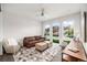 Bright living room boasts modern decor, large windows, and hardwood floors at 6 Wilder Ln, Littleton, CO 80123