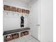 Functional mudroom with built-in storage, bench, and tiled floor at 6 Wilder Ln, Littleton, CO 80123