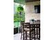 Outdoor seating area featuring a stone wall, comfortable chairs, and a mounted television at 6 Wilder Ln, Littleton, CO 80123