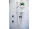 Close-up of the modern shower with a rainfall shower head and built-in corner shelves at 6 Wilder Ln, Columbine Valley, CO 80123