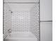 A modern, tiled bathtub and shower, clean white subway tile with black trim at 1350 Josephine St # 508, Denver, CO 80206