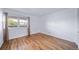 Bedroom with large window providing natural light and hardwood floors at 1350 Josephine St # 508, Denver, CO 80206