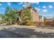 Brick condo building exterior with lush trees and Tudor-style architectural details at 1350 Josephine St # 508, Denver, CO 80206