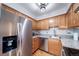 Kitchen with stainless steel refrigerator, dishwasher, sink, granite countertops, and hardwood floors at 1350 Josephine St # 508, Denver, CO 80206