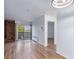 Living room with a brick fireplace and screen, plus hardwood floors, and access to the balcony at 1350 Josephine St # 508, Denver, CO 80206