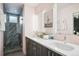 Elegant bathroom with a double vanity and a large shower at 1615 Julian St # 102, Denver, CO 80204