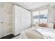 Bedroom with white built-in closet and patterned walls at 1615 Julian St # 102, Denver, CO 80204