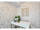 Stylish home office features gold and white patterned walls, a white desk, and decor at 1615 Julian St # 102, Denver, CO 80204