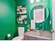 Stylish powder room with a green accent wall and modern vanity at 1615 Julian St # 102, Denver, CO 80204