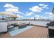 Spacious rooftop deck with fire pit, seating, and grill at 1615 Julian St # 102, Denver, CO 80204