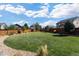 Large backyard with grassy area, gravel landscaping, and wooden fence at 25146 E 1St Ave, Aurora, CO 80018