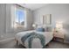 Cozy bedroom with striped bedding and wood nightstand at 25146 E 1St Ave, Aurora, CO 80018